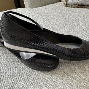 Black patent ballerina flat with ankle strap.